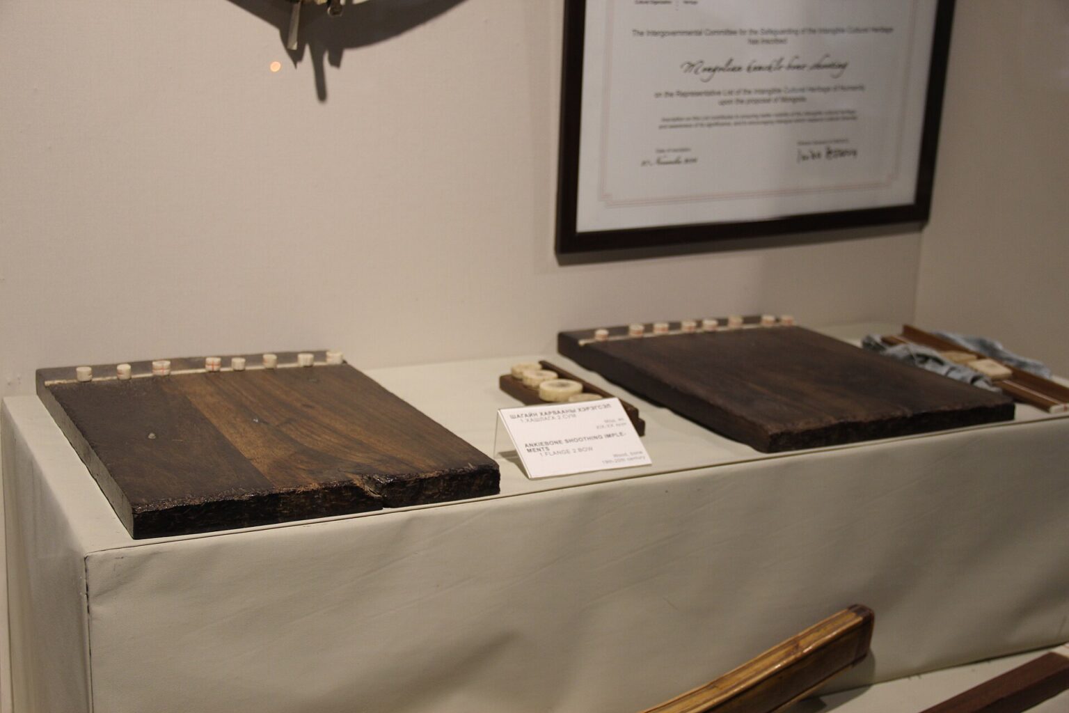 Mongolian Bone and Horn Crafts: Tools, Games and Ornament 3 Traditional Mongolian anklebone shooting tools in a museum display