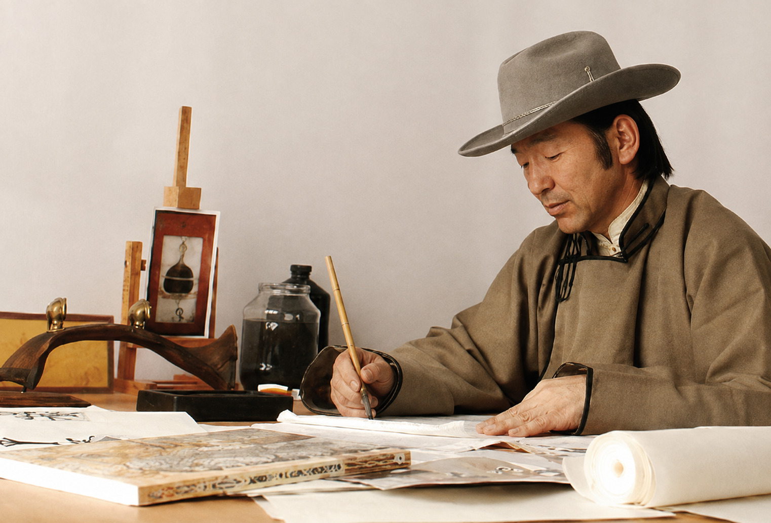 Mongolian calligrapher writing with a brush